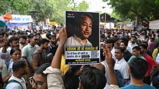 A supporter holds a photograph of climate activist Sonam Wangchuk during a sit-in protest demanding the resignation of India's Education Minister Dharmendra Pradhan over alleged NEET examination irregularities in New Delhi on July 19, 2026. (AFP)
