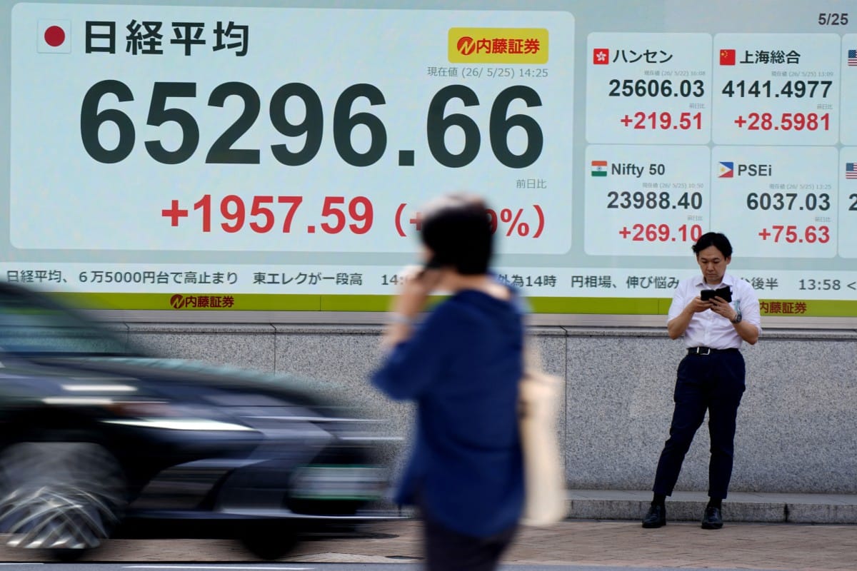 An electronic quotation board (L) displays the Nikkei Stock Average on the Tokyo Stock Exchange along a street in Tokyo on May 25, 2026. (Photo by Kazuhiro NOGI / AFP)