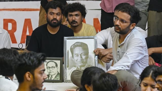 Cockroach Janta Party (CJP) founder Abhijeet Dipke (L) sits on an indefinite hunger strike demanding the resignation of India's Education Minister Dharmendra Pradhan over alleged NEET examination irregularities in New Delhi on July 18, 2026. (AFP)