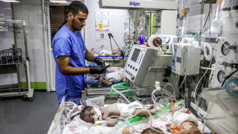 A medical worker checks on prematurely-born babies lying in infant warmer beds at the overcrowed neonatal intensive care unit (NICU) at Nasser Medical Complex in Khan Yunis in the southern Gaza Strip on September 7, 2026. (AFP)