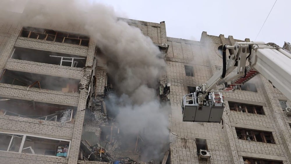 This handout photograph, taken and released by the State Emergency Service of Ukraine on August 9, 2026 shows firefighters extinguishing a fire in a damaged residential building following a Russian air attack in the eastern city of Kharkiv, amid the Russi