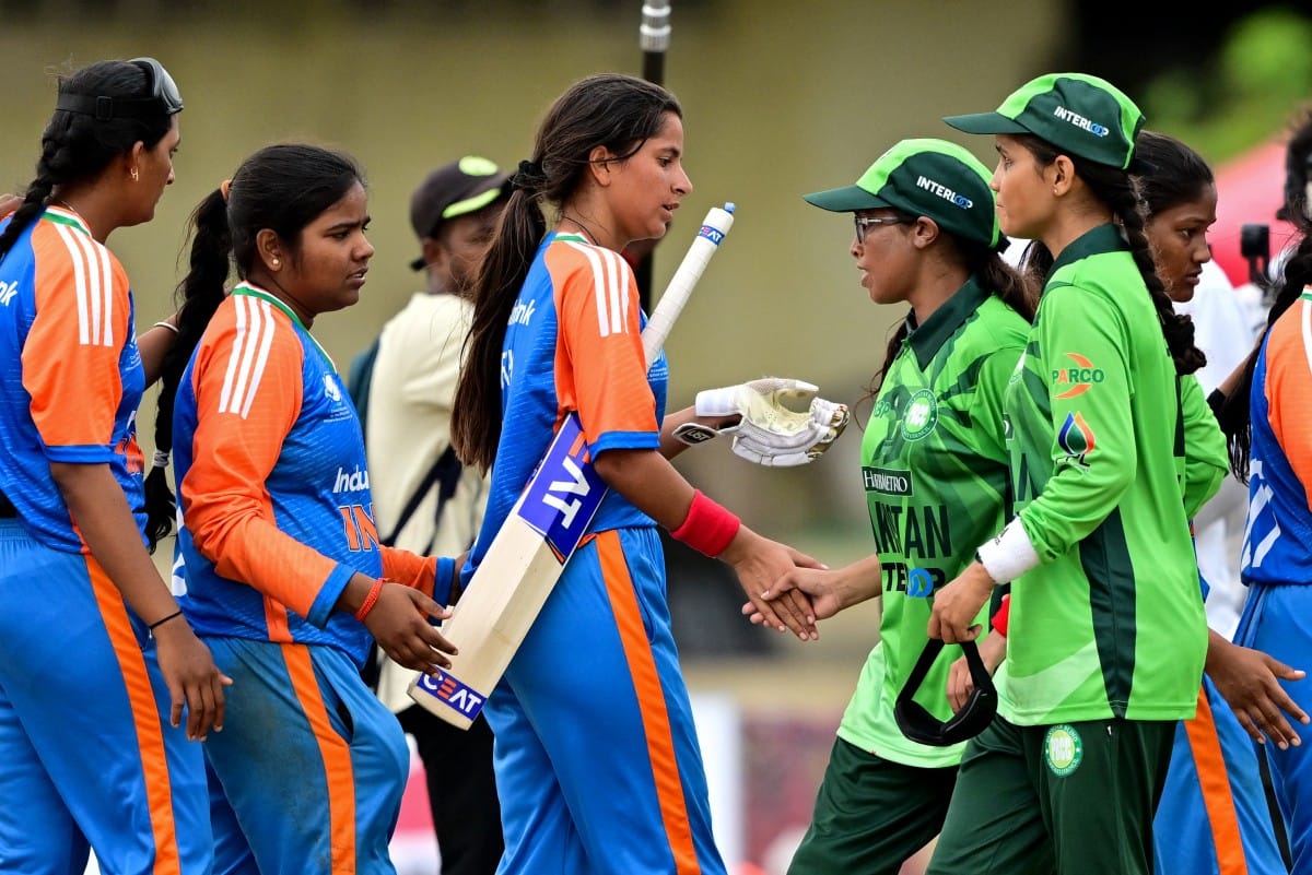 Pakistan's captain Nimra Rafique (3R) shakes hands with India's players