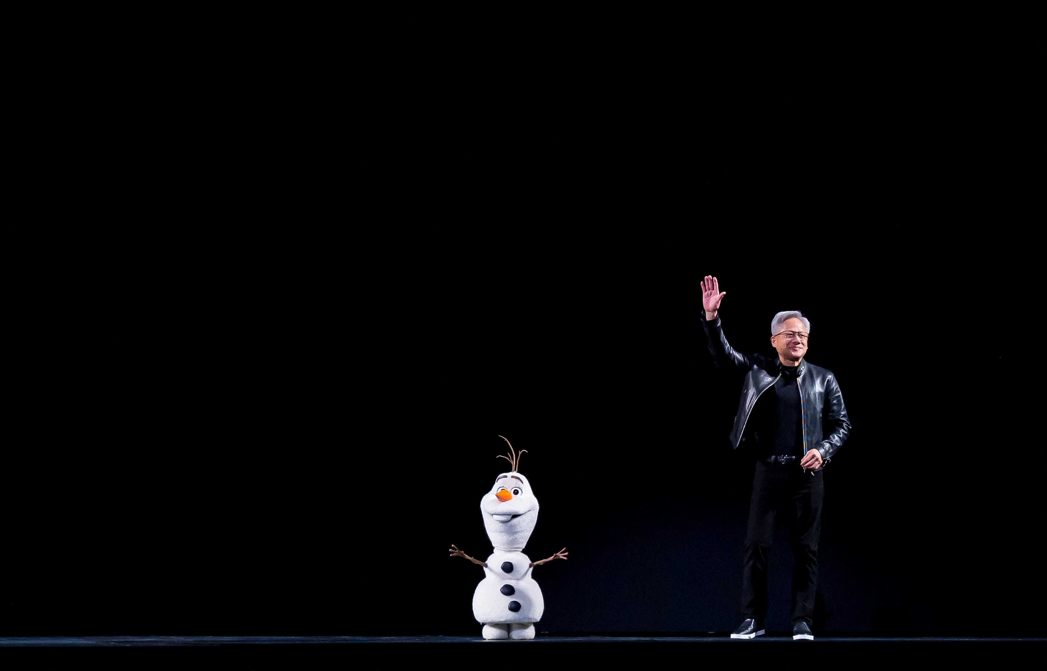 Nvidia CEO Jensen Huang is joined at the stage by a Disney animatronic robot during his keynote address at the company's annual GTC developers conference at the SAP Center in San Jose, California
