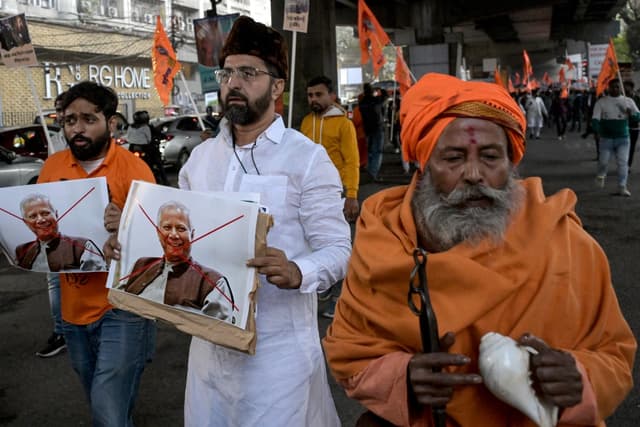 Bharatiya Janata Party (BJP) and religious activists with posters of Muhammad Yunus, Chief Adviser of Bangladesh's interim government shout slogans during a protest near the Deputy High Commission of Bangladesh office in Kolkata on December 22, 2025.