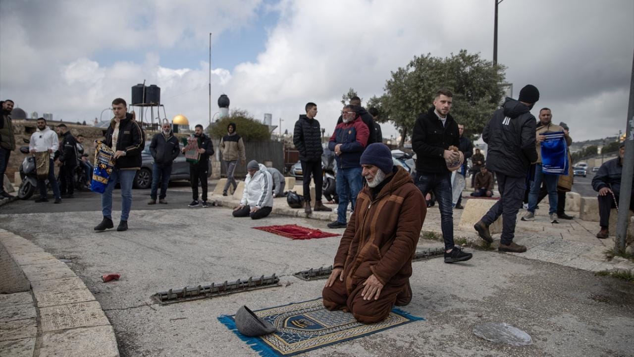 Palestinians perform Friday prayer on the streets in East Jerusalem on March 27, 2026 as the Israeli forces continue to impose restriction to Palestinians from entering the Dome of the Rock of Masjid Al-Aqsa for Friday prayers, in Jerusalem. (AFP)