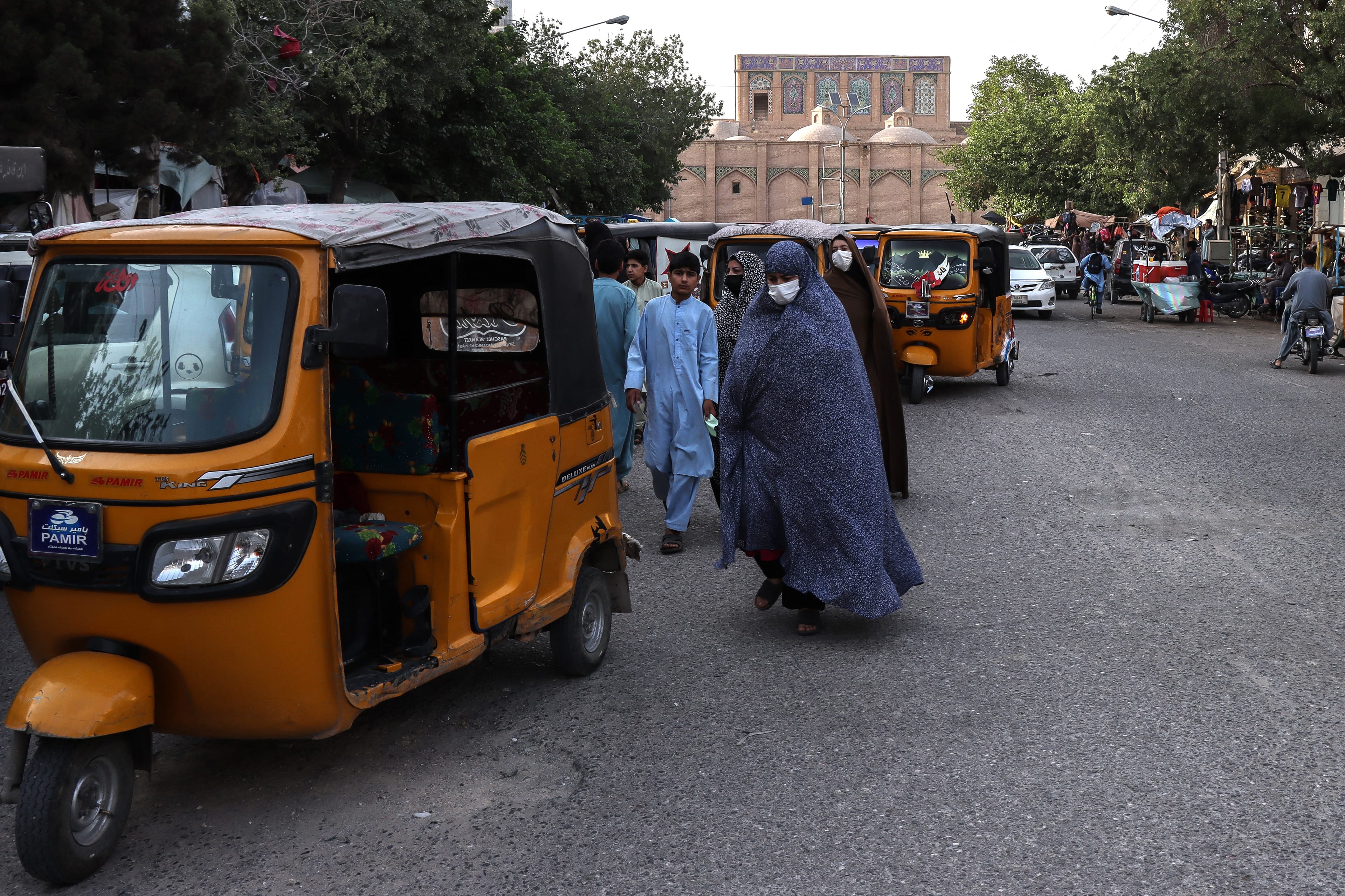 Afghan women wearing chador walk along the street near the Grand Mosque in Herat on June 8, 2026. (AFP)
