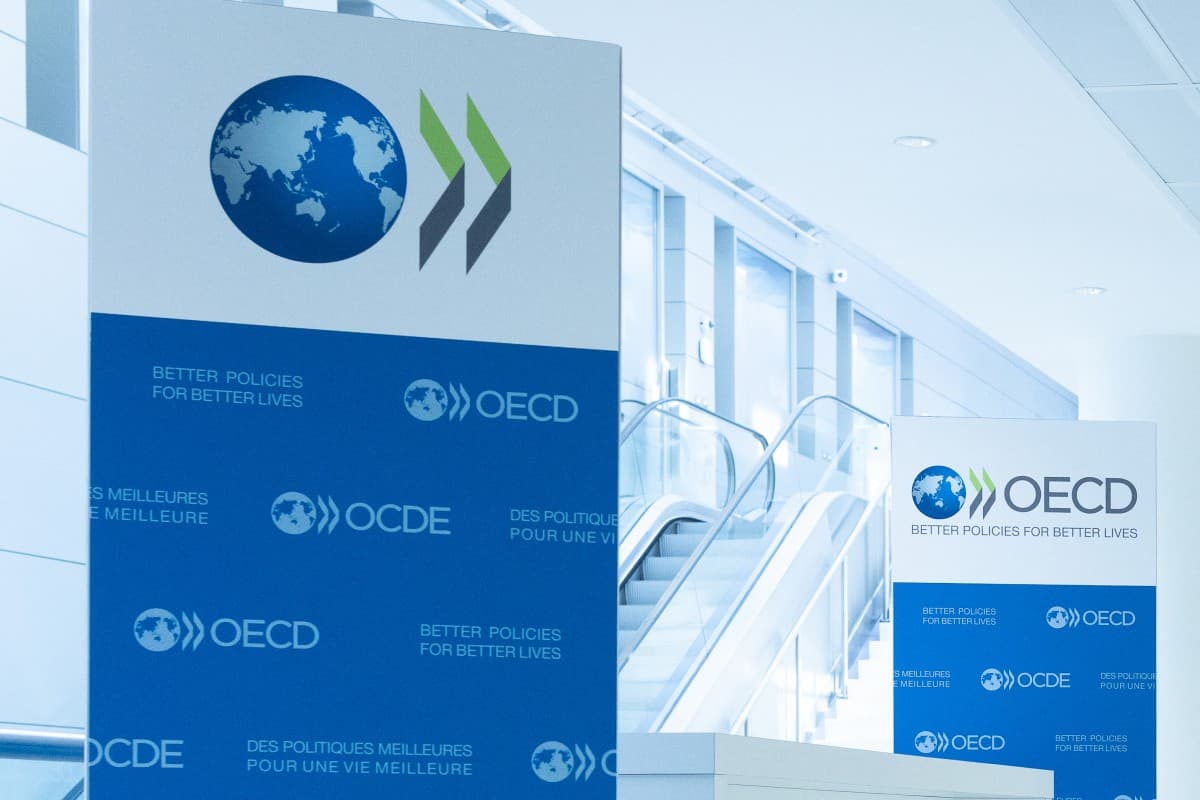 This photograph, taken on September 22, 2025, shows the logo of the Organization for Economic Cooperation and Development (OECD) displayed on banners at the OECD headquarters in Paris. (AFP)
