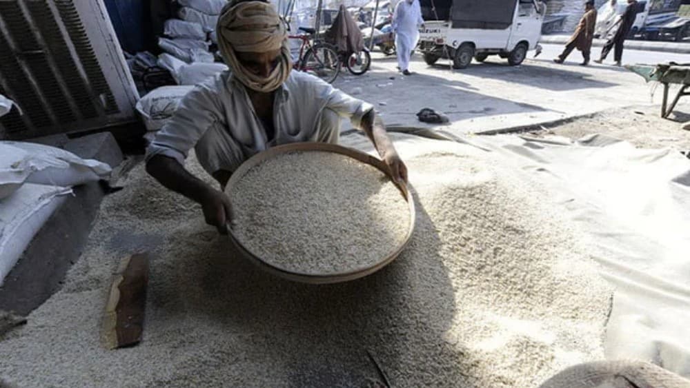 FILE: A Pakistani worker sieves a heap of rice at a wholesale market in Rawalpindi (AFP)