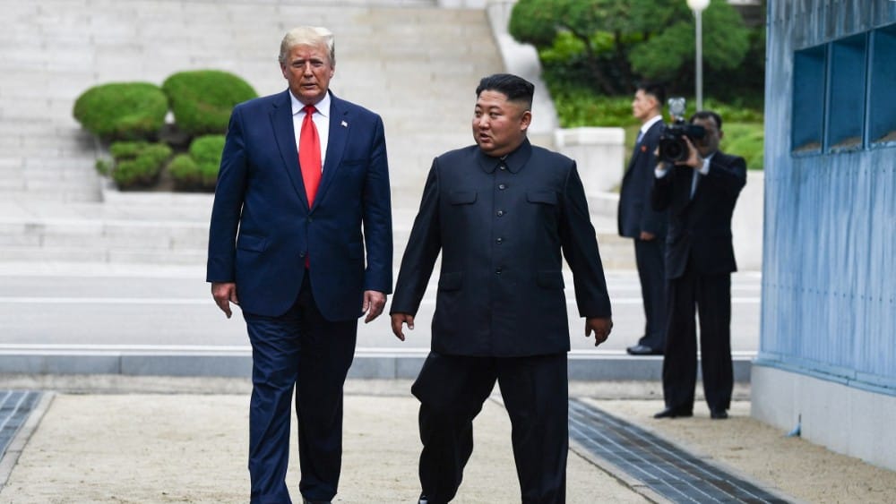 North Korea's leader Kim Jong Un and US President Donald Trump cross south of the Military Demarcation Line that divides North and South Korea, after Trump briefly stepped over to the northern side, in the Joint Security Area (JSA) of Panmunjom in the Dem