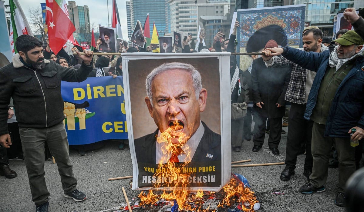 Protestors set fire to an image depicting Israeli Prime Minister Benjamin Netanyahu as they gather to protest against the US and Israel attack of Iran and the killing of the Supreme leader in front of Israel Consulate in Istanbul on March 1, 2026. (AFP)