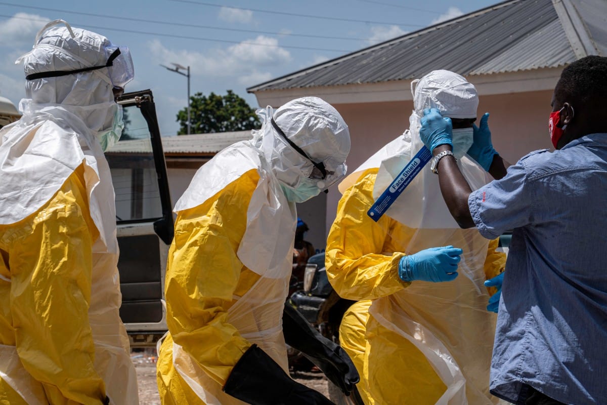 Response team members are helped to wear protective suits before burying a person suspected of having died from Ebola in Bunia, in the eastern Democratic Republic of the Congo, on May 25, 2026. (AFP)