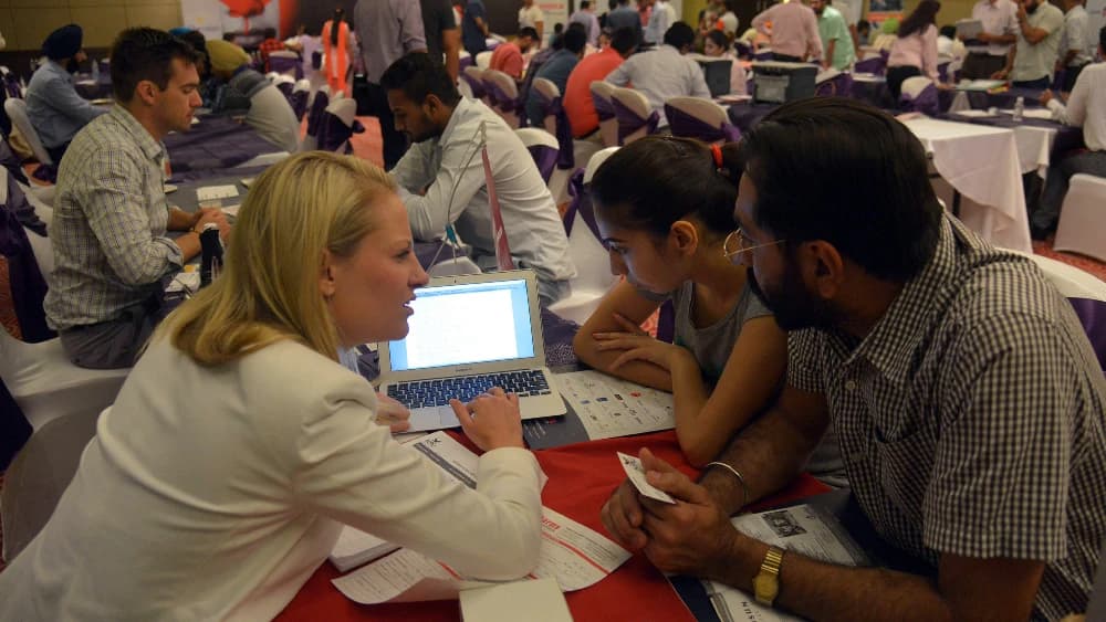 Indian students listen to Director of Partnerships and Pathways at KPU International Anita Hamm (L) at a Canadian education fair in Amritsar on September 16, 2015. (AFP/File)