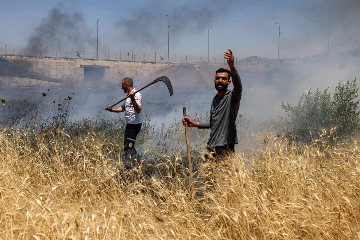 Men attempt to extinguish a fire in a field in the Palestinian town of Huwara in the occupied West Bank on June 6, 2026, after a reported arson attack by Israeli settlers, according to local officials. (Photo: AFP)