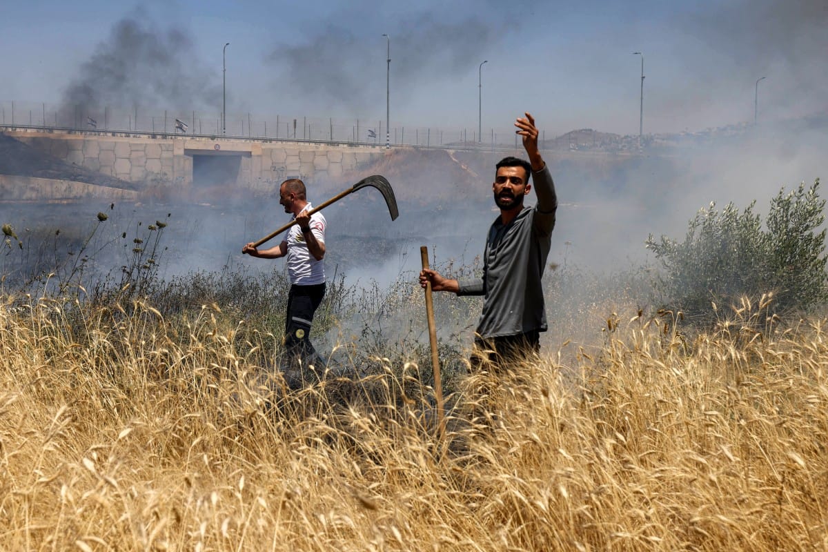 Men attempt to extinguish a fire in a field in the Palestinian town of Huwara in the occupied West Bank on June 6, 2026, after a reported arson attack by Israeli settlers, according to local officials. (Photo: AFP)