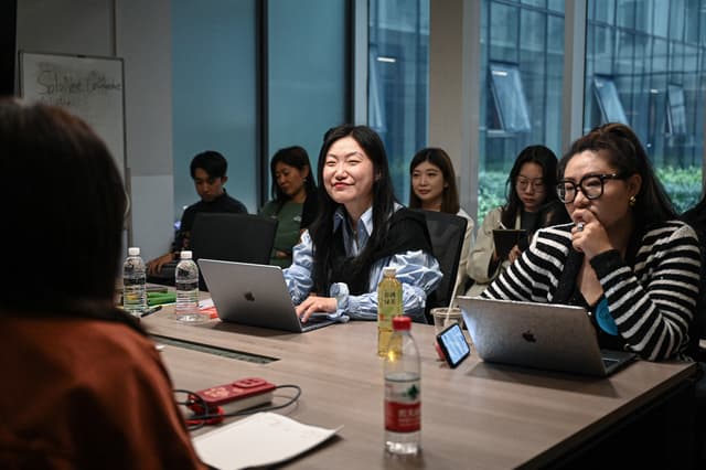 The photo taken on April 12, 2026 shows founder of one-person company SoloNest Karen Dai (C) sharing her experience with participants during a coffee chat at a conference room in Shanghai.