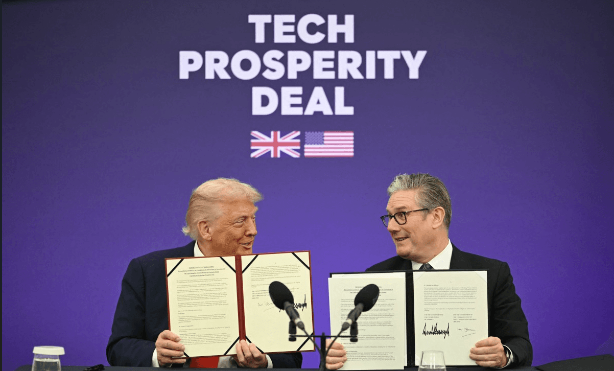 Britain's Prime Minister Keir Starmer (R) and US President Donald Trump (L) show off their signed technology prosperity deal at a Business event at Chequers, in Aylesbury, central England, on September 18, 2025 (AFP/File)