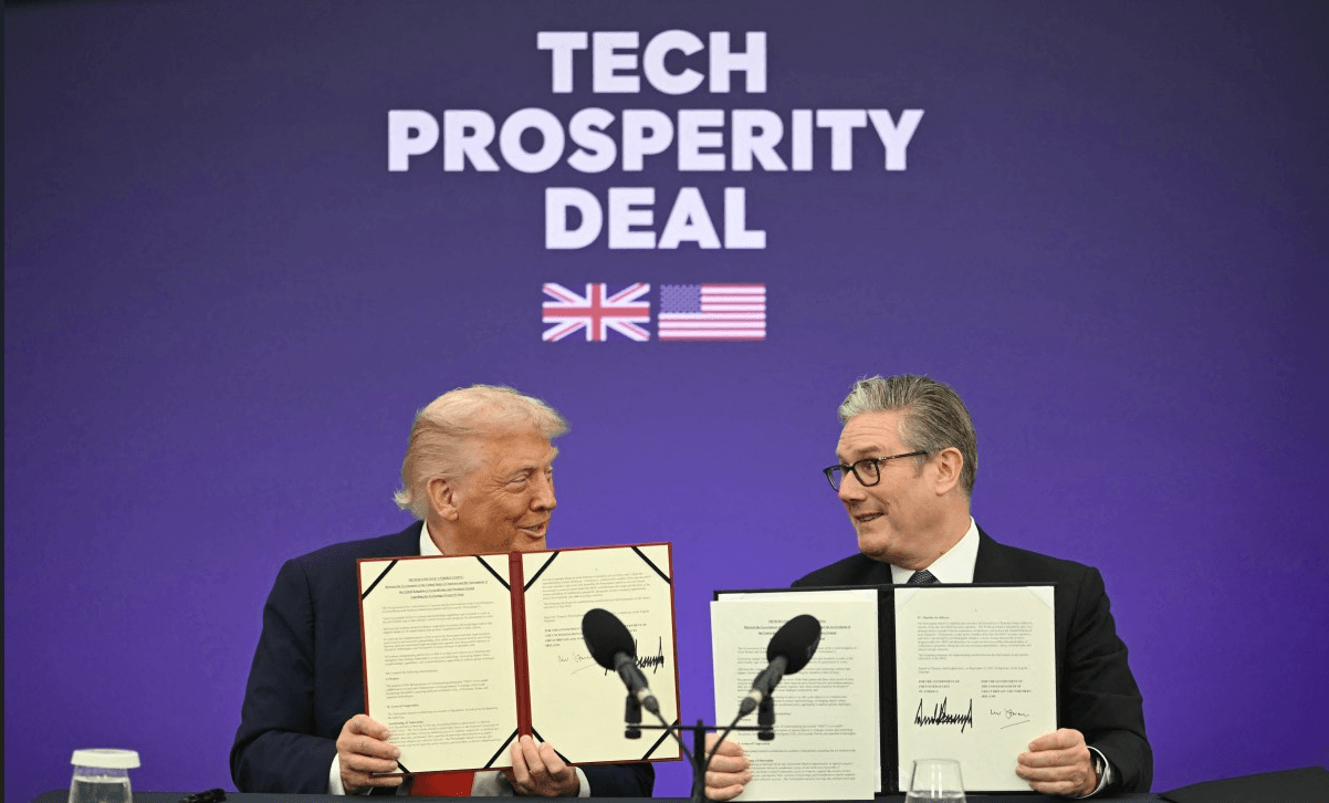 Britain's Prime Minister Keir Starmer (R) and US President Donald Trump (L) show off their signed technology prosperity deal at a Business event at Chequers, in Aylesbury, central England, on September 18, 2025 (AFP/File)