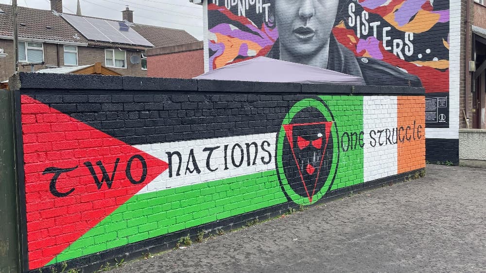 The flags of Palestine and Ireland are painted side by side symbolizing the political solidarity between the resistance movements and the Palestinian cause within this Irish nationalist and republican community in Derry Northern Ireland on August 02 2026.