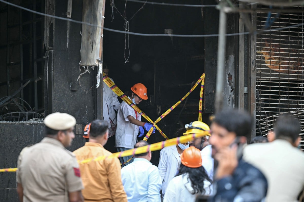 Forensics team members inspect the site following a fire that broke out at a hotel in New Delhi on June 3, 2026 (AFP)