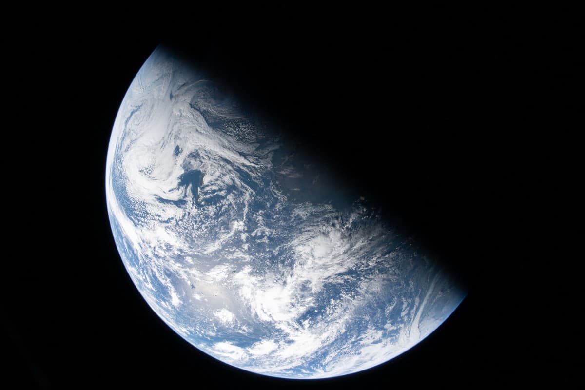 This handout picture provided by NASA shows Earth as seen through the Orion spacecraft’s window, photographed by NASA astronaut Reid Wiseman, commander of Artemis II, on April 2, 2026, after completing the translunar injection burn. (AFP)