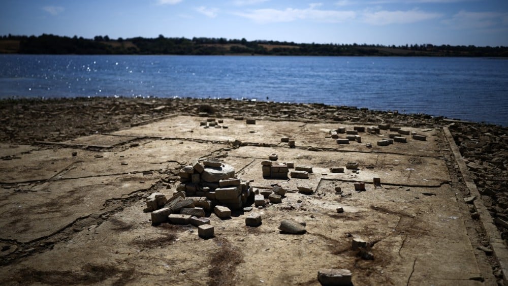 The remains of buildings revealed by the the persistent hot weather and drought, are pictured in the reservoir bed of Anglian Water's Rutland Water -- a reservoir created by the flooding of hamlets Lower and Middle Hambleton -- in Upper Hambleton, central