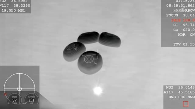 This screengrab taken from NASA+ livestream shows the SpaceX Crew Dragon Endeavour spacecraft with parachutes deployed before splash down in the Pacific Ocean off the coast of San Diego, California, on January 14, 2026, carrying NASA astronauts Mike Finck
