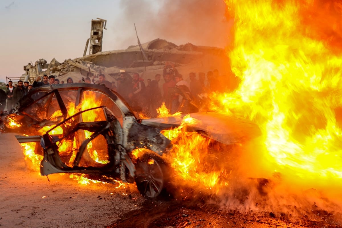 Flames rise after a strike on the vehicle of Palestinian journalist Mohammed Washeha in southern Gaza City on April 8, 2026. (AFP)