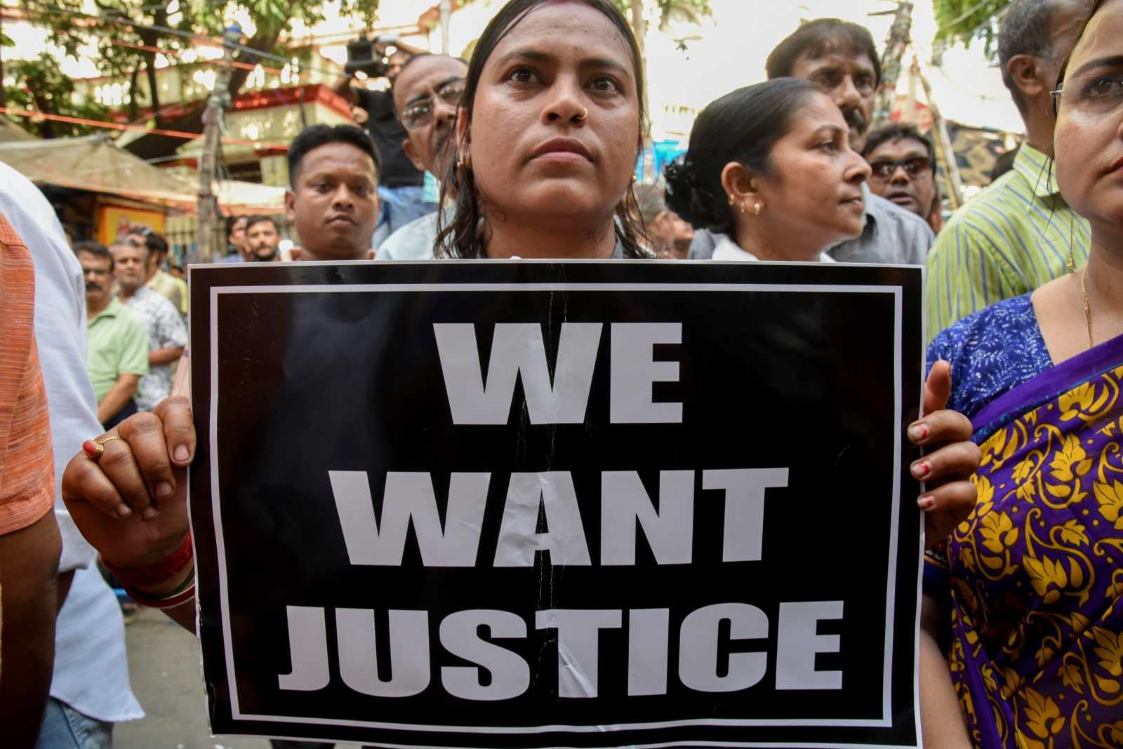 A protester displays a “We Want Justice” sign in Kolkata, India, on August 9, 2025 during a rally demanding justice for a junior doctor raped and killed at R G Kar Medical College Hospital. (AFP)