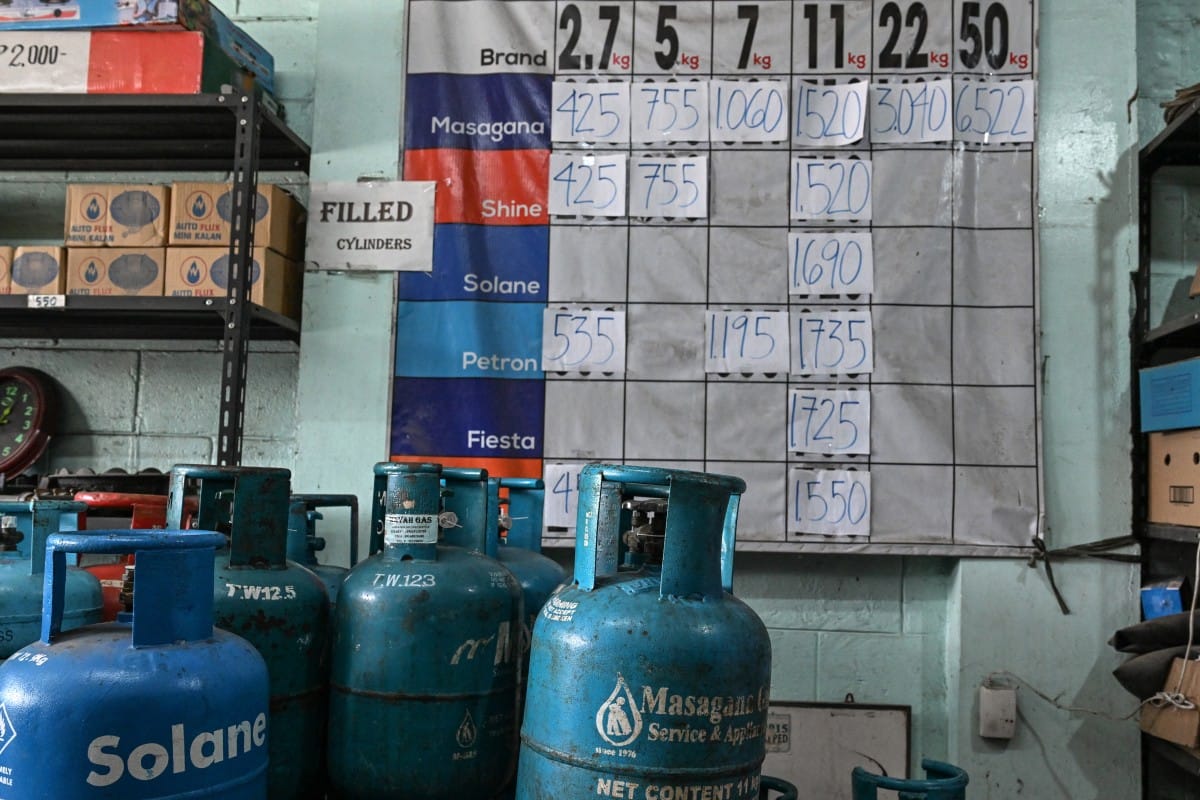 Prices for liquefied petroleum gas (LPG) are displayed next to canisters at a store in Manila on April 7, 2026. (Photo by Jam STA ROSA / AFP)