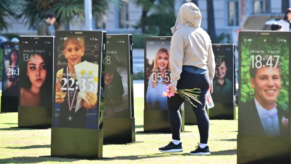Images of deceased children are displayed at the 'Lost Screen Memorial', an art installation of large-scale smartphones featuring 50 children who lost their lives due to online harm, in Los Angeles, California on February 13, 2026. (Photo: AFP)
