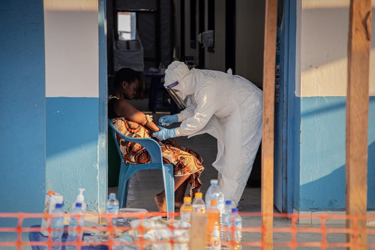 A healthcare worker takes samples from a patient suffering from Ebola virus disease at the Ebola Treatment Center of the Center Médical Évangélique (CME), in Bunia, Ituri, in the east of the Democratic Republic of Congo on June 23, 2026. (Photo by Benedic