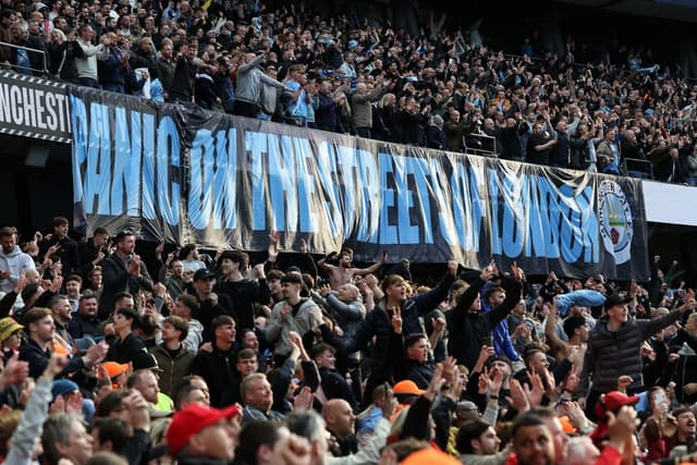 Manchester City supporters cheer at the end of the English Premier League football match between Manchester City and Arsenal at the Etihad Stadium in Manchester, north west England, on April 19, 2026. (AFP)