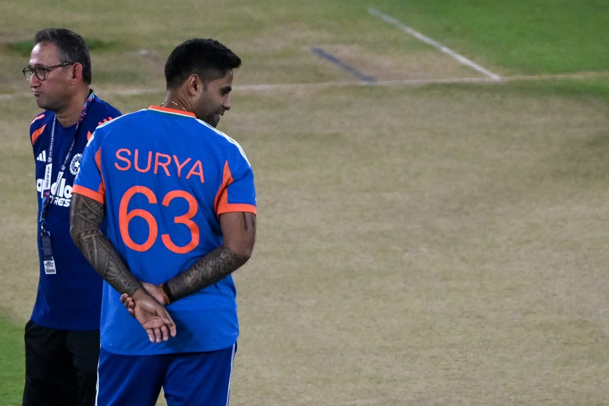 India's captain Suryakumar Yadav (R) looks at the pitch as he interacts with the chairman of the Indian cricket selection committee Ajit Agarkar during the training session on the eve of the 2026 ICC Men's T20 Cricket World Cup final match against New Zea