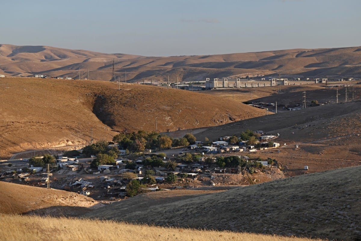 A general view of the Palestinian Bedouin village of Khan al-Ahmar is pictured in the Israeli-occupied West Bank, against the backdrop of Israeli settlement of Mishor Adumim, on May 20, 2026. (AFP)