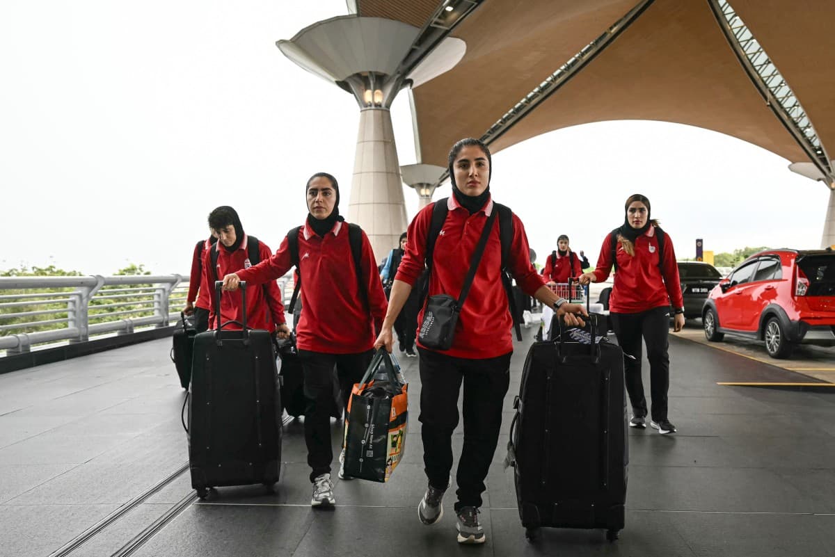 Members of Iran's women's football team arrive at the Kuala Lumpur International Airport in Sepang on March 16, 2026, after staying in a hotel in the Malaysian capital while awaiting the next leg of their journey home. (AFP)