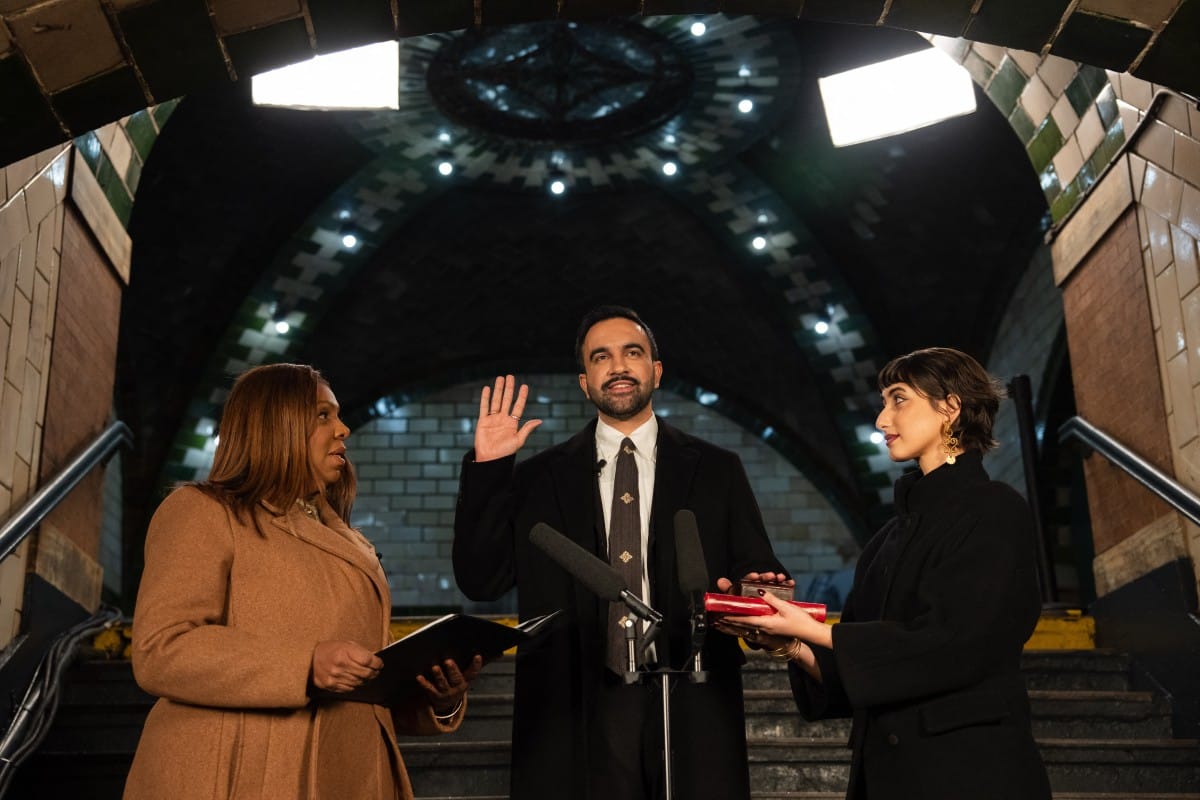 New York mayor-elect Zohran Mamdani (C) is sworn in as New York Attorney General Letitia James (L) and Rama Duwaji look on at midnight on December 31, 2025, in New York as he immediately begins his term on January 1, 2026. New York mayor-elect Zohran Mamd