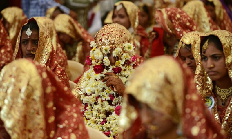File: This picture shows an Indian bride with her face covered with flower garlands during a mass wedding ceremony in Ahmedabad, India. (AFP)