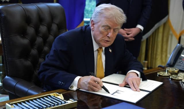 US President Donald Trump signs an executive order during a ceremony in the Oval Office of the White House on March 16, 2026, in Washington, DC (AFP)