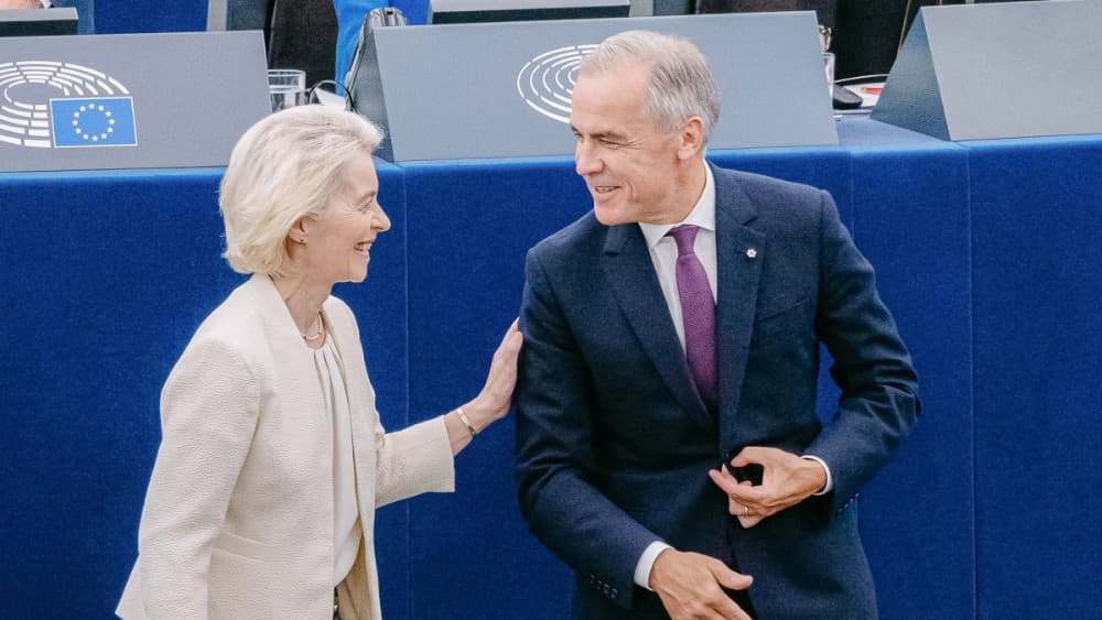 This handout photograph taken and released by the European Union on September 16, 2026 shows European Commission President Ursula von der Leyen (L) greeting Canada's Prime Minister Mark Carney during her annual keynote address to the European Parliament i