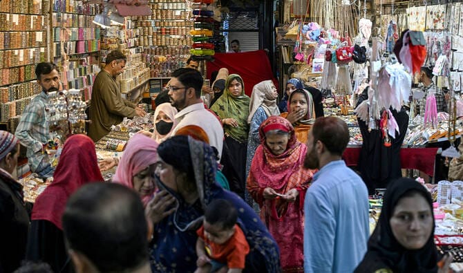 Pakistanis shop at a market for the Eid al-Fitr celebrations during the last week of the Islamic holy fasting month of Ramadan in Karachi on March 17, 2026. (AFP)