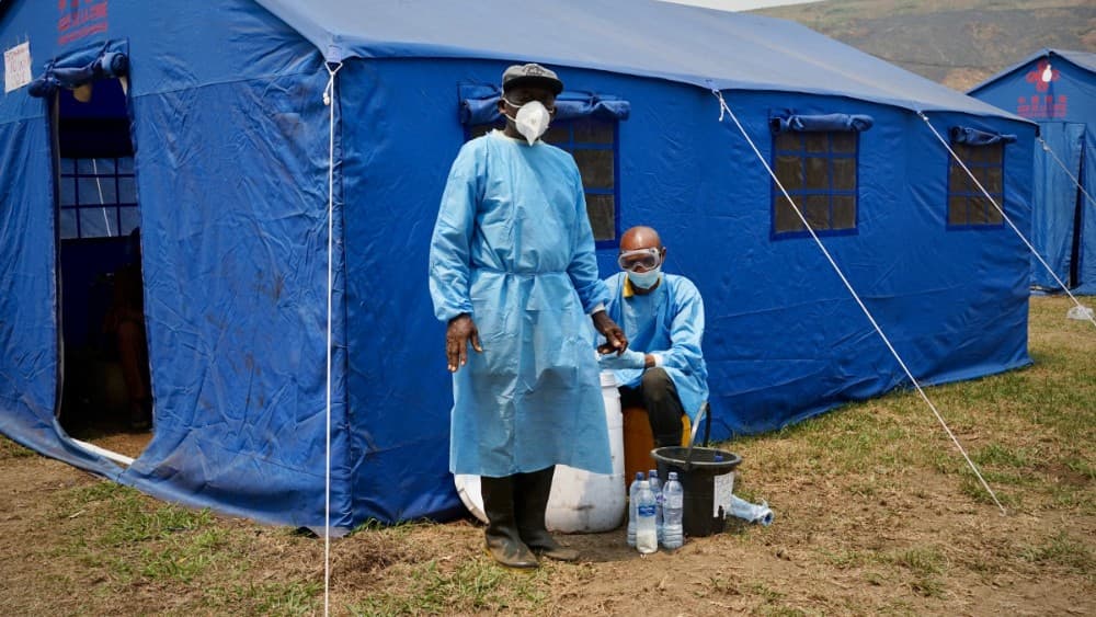 Health workers wearing protective equipment get ready to disinfect a boat at the port of Bende-Bende, in Maluku, on August 20, 2026.Photo by SOPHIE DOUCE / AFP)
