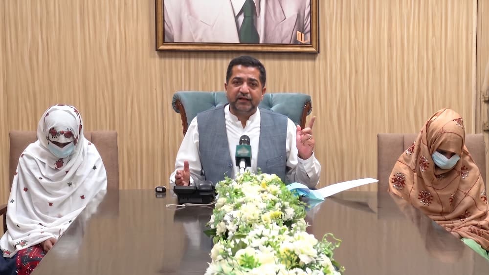 Balochistan Home Minister Mir Zia Ullah Langov, center, speaks during a press conference in Pakistan on Saturday, with 16-year-old Zainab, right, and her 12-year-old cousin, Fatima, left. (PTV)