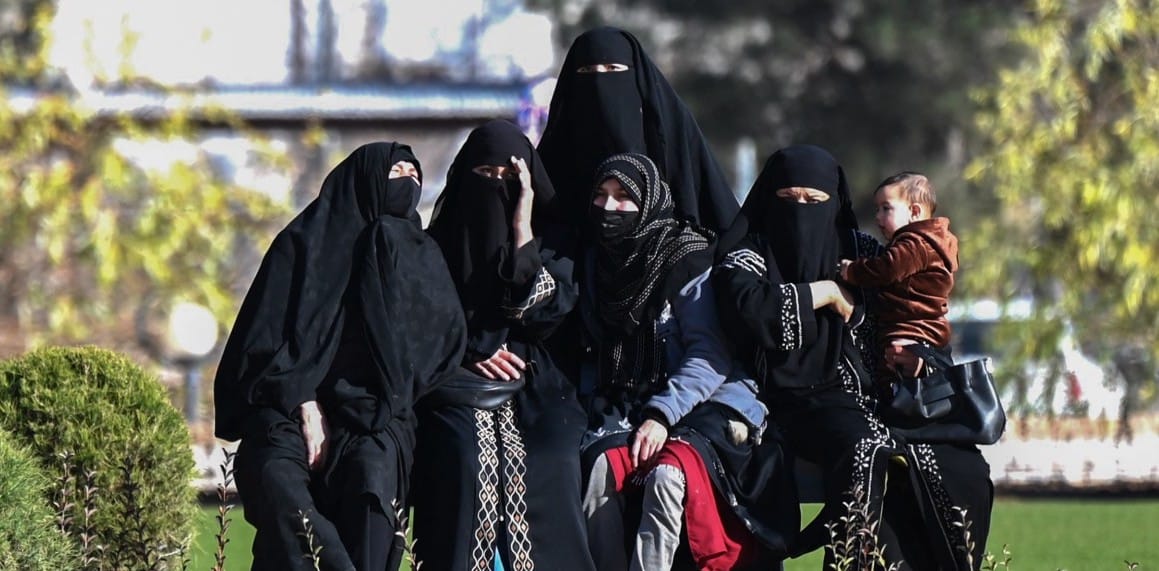 Afghan women rest outside the Grand Mosque in Herat on January 8, 2026. (Photo by Wakil KOHSAR / AFP)
