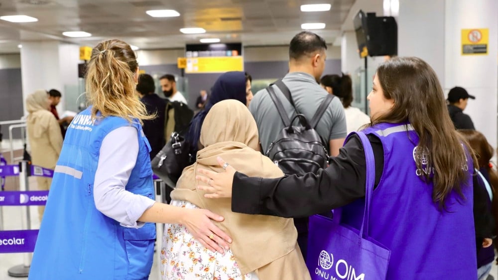 Staff from UNHCR and IOM welcome Afghan refugee families arriving at São Paulo International Airport. (UNHCR)