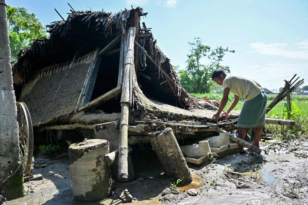 A villager looks for his belongings in his damaged house following monsoon floods in Dhemaji town in India’s Assam on June 30, 2026. (Photo: AFP)