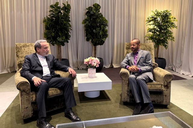 In this handout photo released by the Iran's Foreign Ministry on February 26, 2026, Iran's Foreign Minister Abbas Araghchi (L) speaks with Oman’s Foreign Minister Badr Albusaidi during their meeting in Geneva.