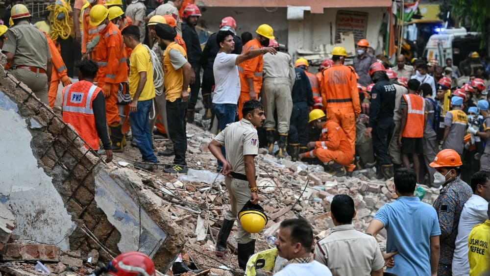 Rescue personnel conduct a search operation for survivors at the site of a building collapse in the Satya Niketan area in New Delhi on September 6, 2026.