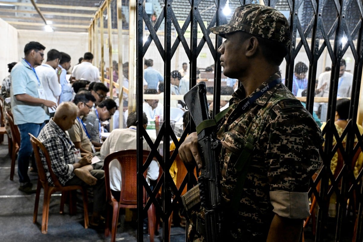 A Central Reserve Police Force (CRPF) personnel stands guard as election officials count votes after the West Bengal Legislative Assembly elections at the Netaji Indoor Stadium in Kolkata on May 4, 2026.