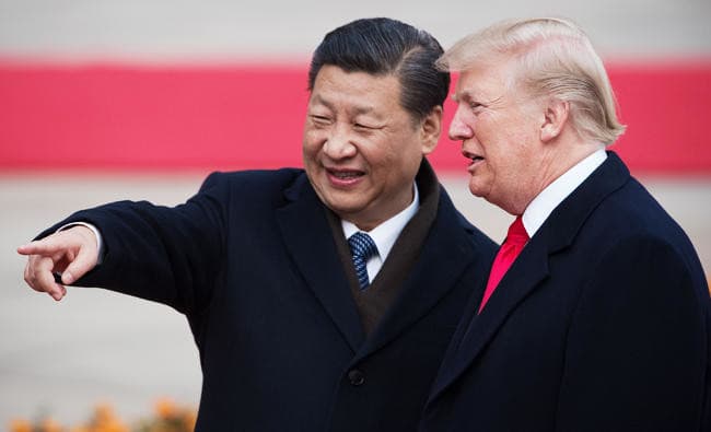 China's President Xi Jinping (L) and US President Donald Trump attend a welcome ceremony at the Great Hall of the People in Beijing. (AFP/File)