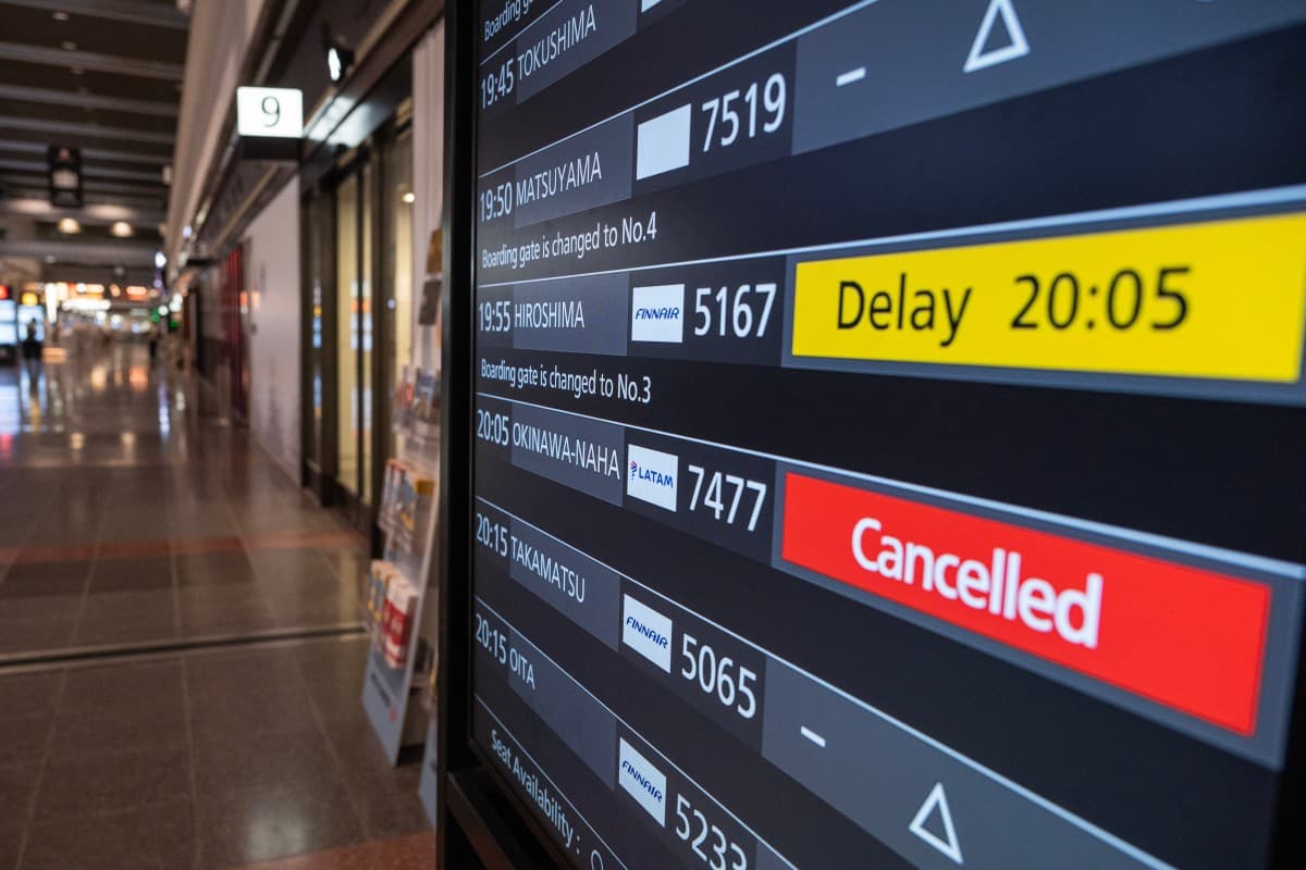 A departures board shows a cancelled flight to Okinawa after Severe Tropical Storm Jangmi shut down the airport there as it moved toward mainland Japan, at Haneda Airport in Tokyo on June 1, 2026, as airlines began suspending service across the region. (P